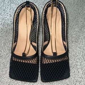 Bottega Veneta fishnet pumps with leather and chain trim.